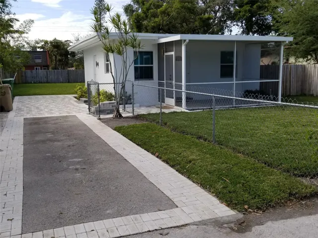 Screend-in porch, paved driveway, chain-link fencing, landscaping