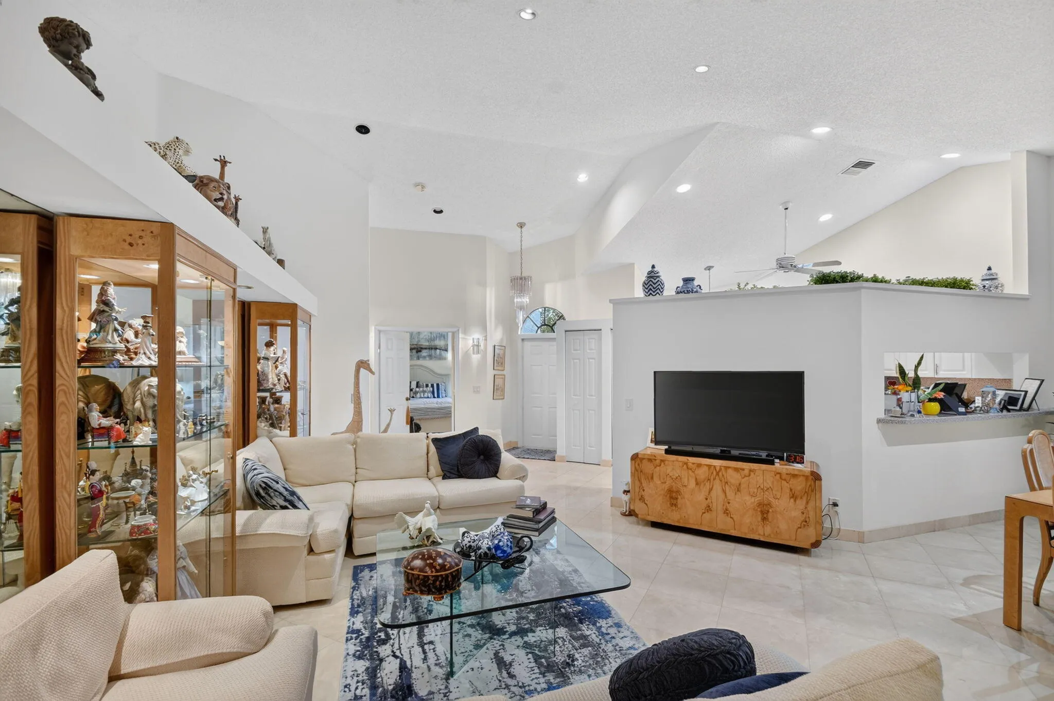 Vaulted ceilings and recessed lighting create an expansive atmosphere