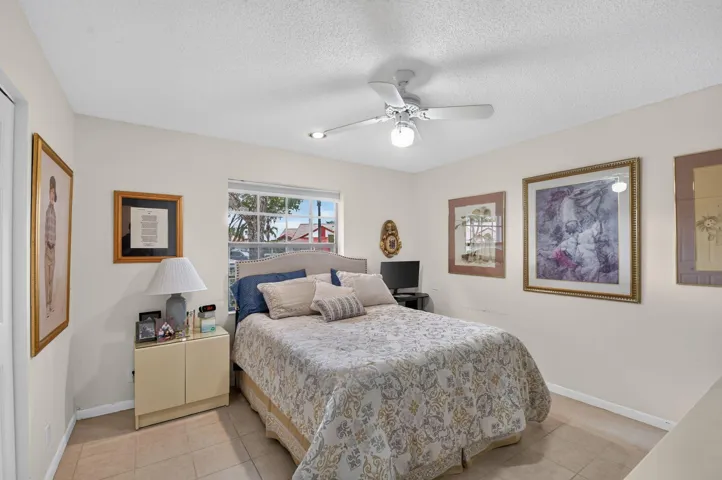 Recessed lighting, ceiling fan, window, and tile flooring