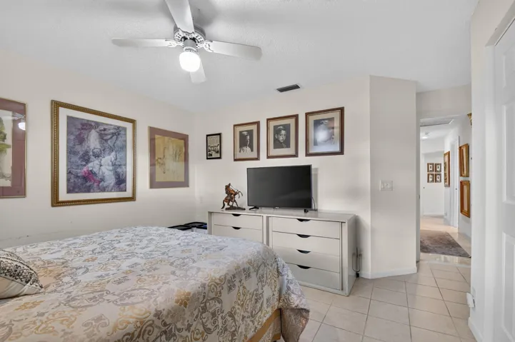 Ceiling fan with integrated lighting, recessed lighting, neutral wall paint, tiled flooring, and a paneled door