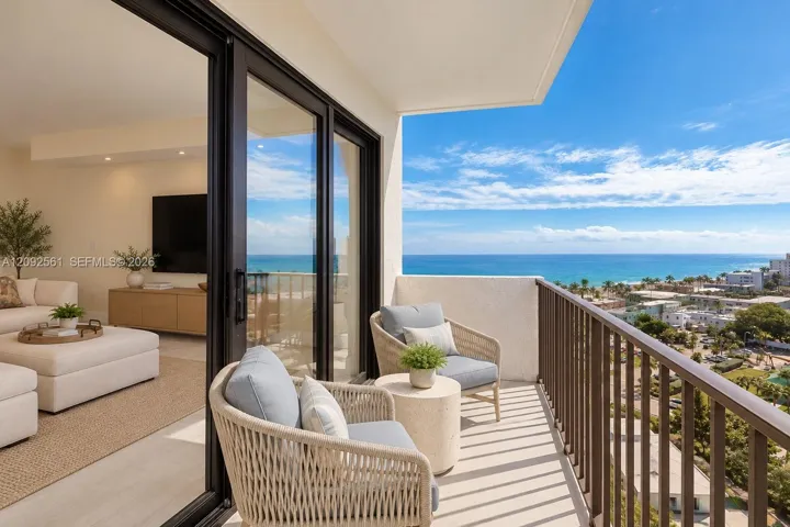 Covered balcony with a metal railing, floor-to-ceiling sliding glass doors, and light-toned flooring