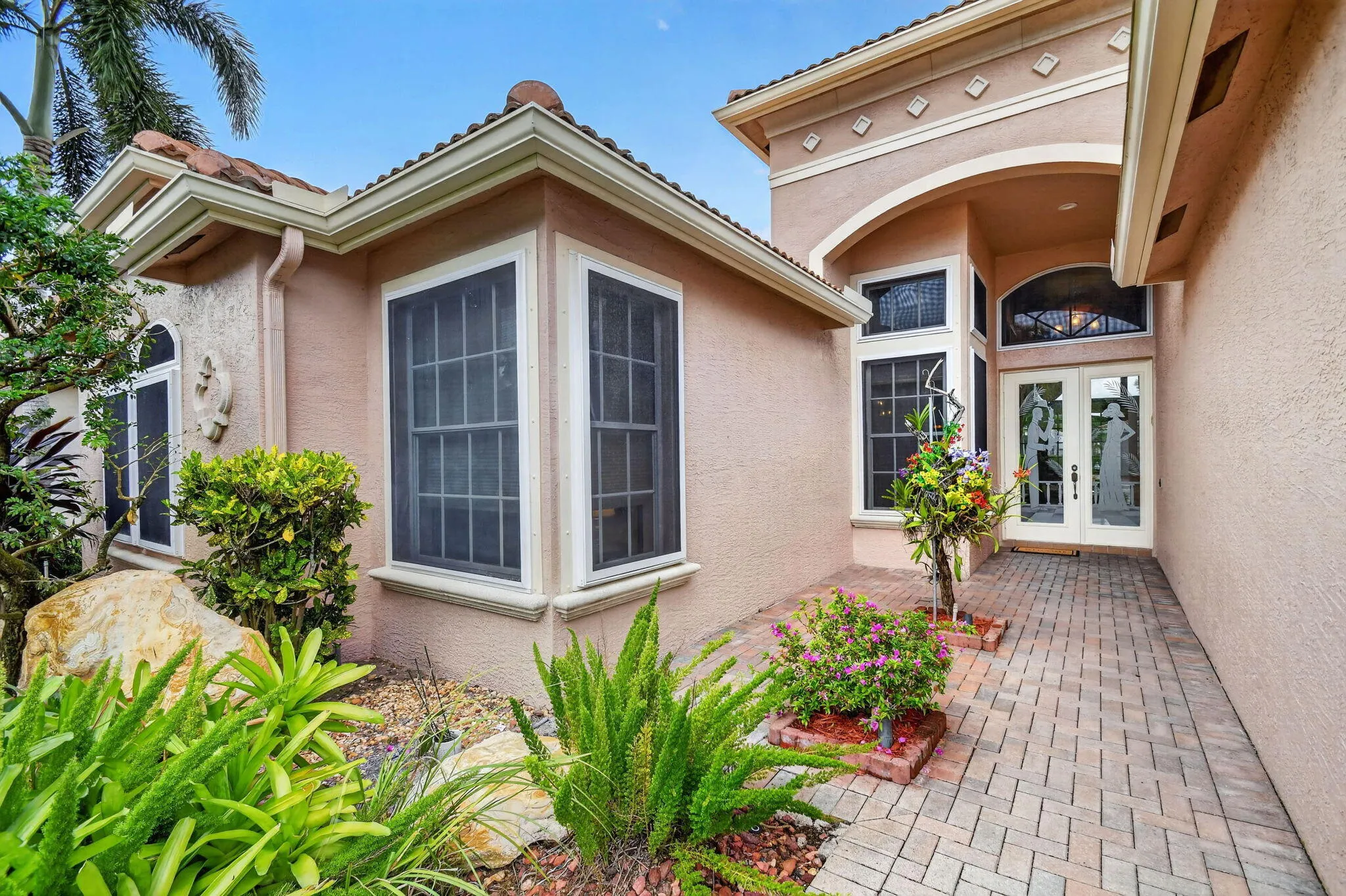 Memorable first impression. Lush Mature Landscaping Front, Rear & Back of Home. Elegant front Door.