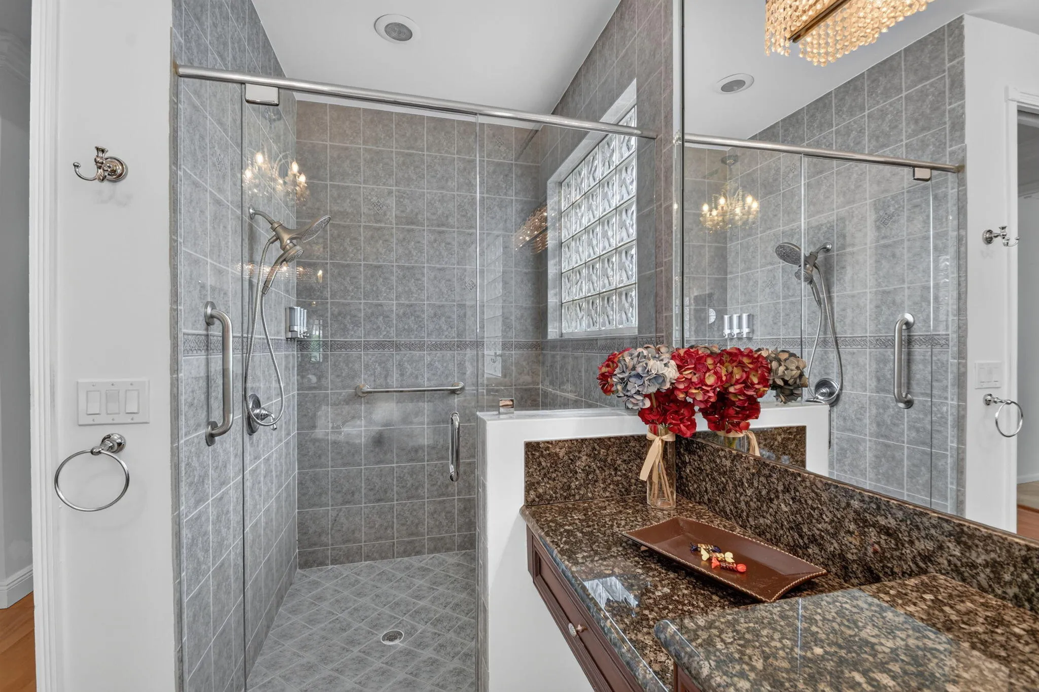 Shower features a built in bench offering both comfort & convenience