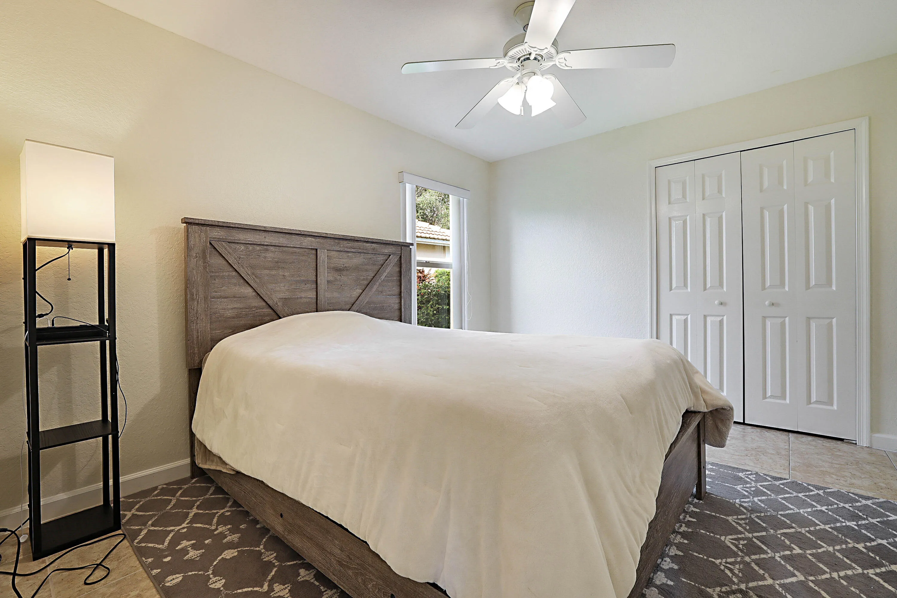 Recessed window, ceiling fan with light fixture, double bifold closet doors, and tile flooring