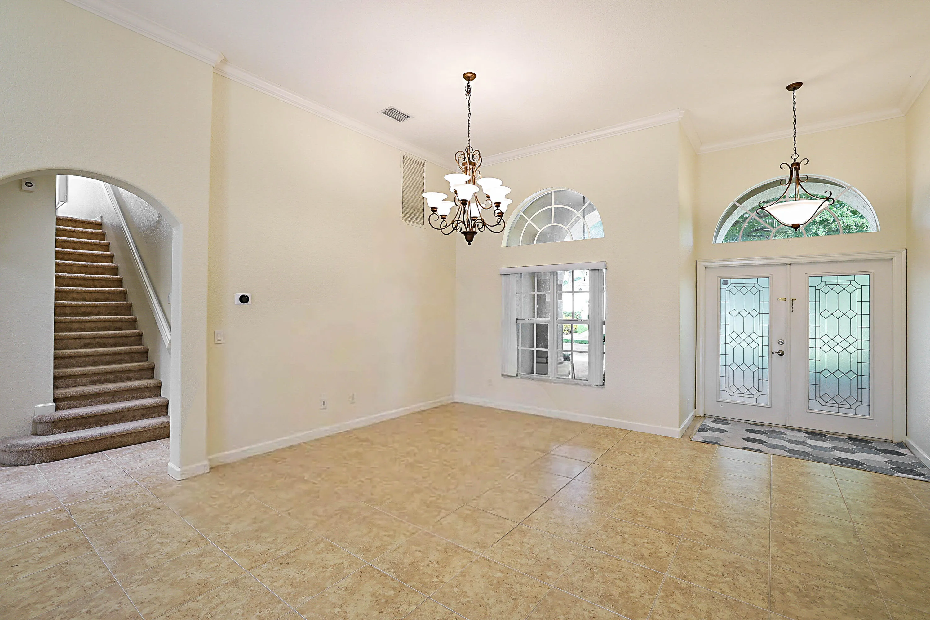 Tiled flooring throughout the main area, vaulted ceilings, and crown molding