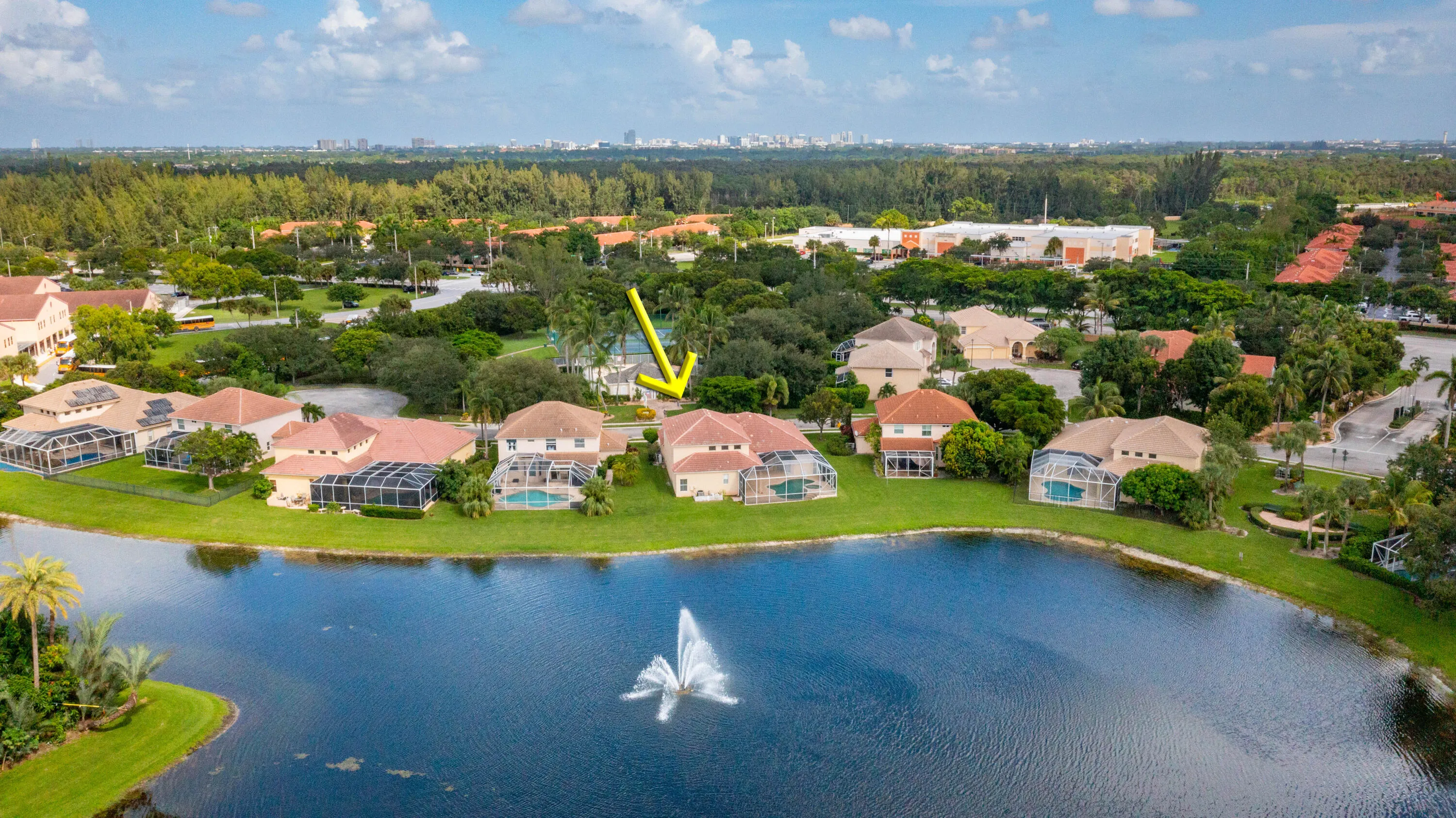 Waterfront property with a private pool, screened patio, and mature landscaping