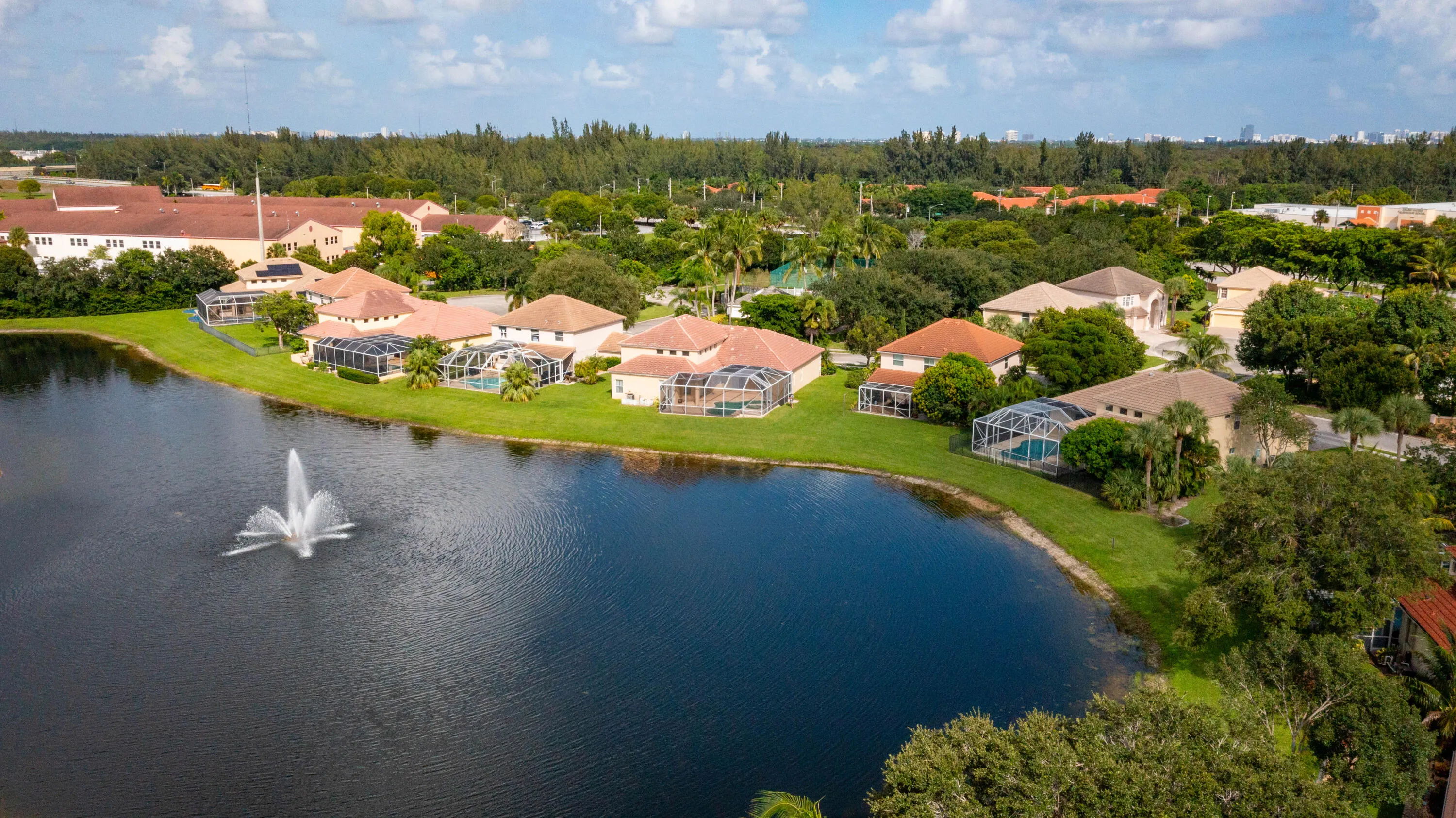 Waterfront estate nestled on a private lake with manicured grounds and mature landscaping
