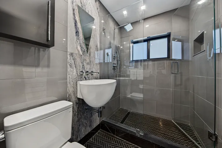 Main bath features a Walk-in shower with a glass enclosure and designer vanity