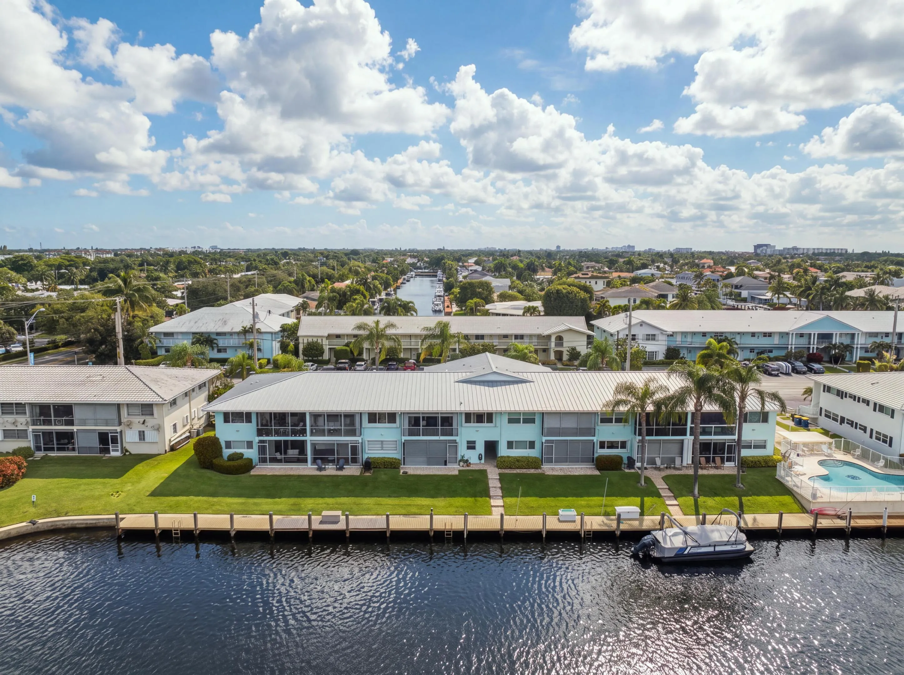 Waterfront property with canal frontage, private dock, and a communal swimming pool