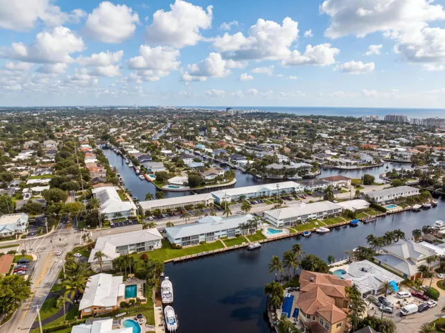 Waterfront community featuring canal access, residential properties, and distant ocean scenery
