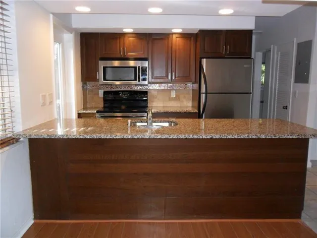 Open concept kitchen with granite and SS appliances