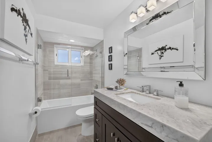 Floating vanity with stone countertop and integrated sink