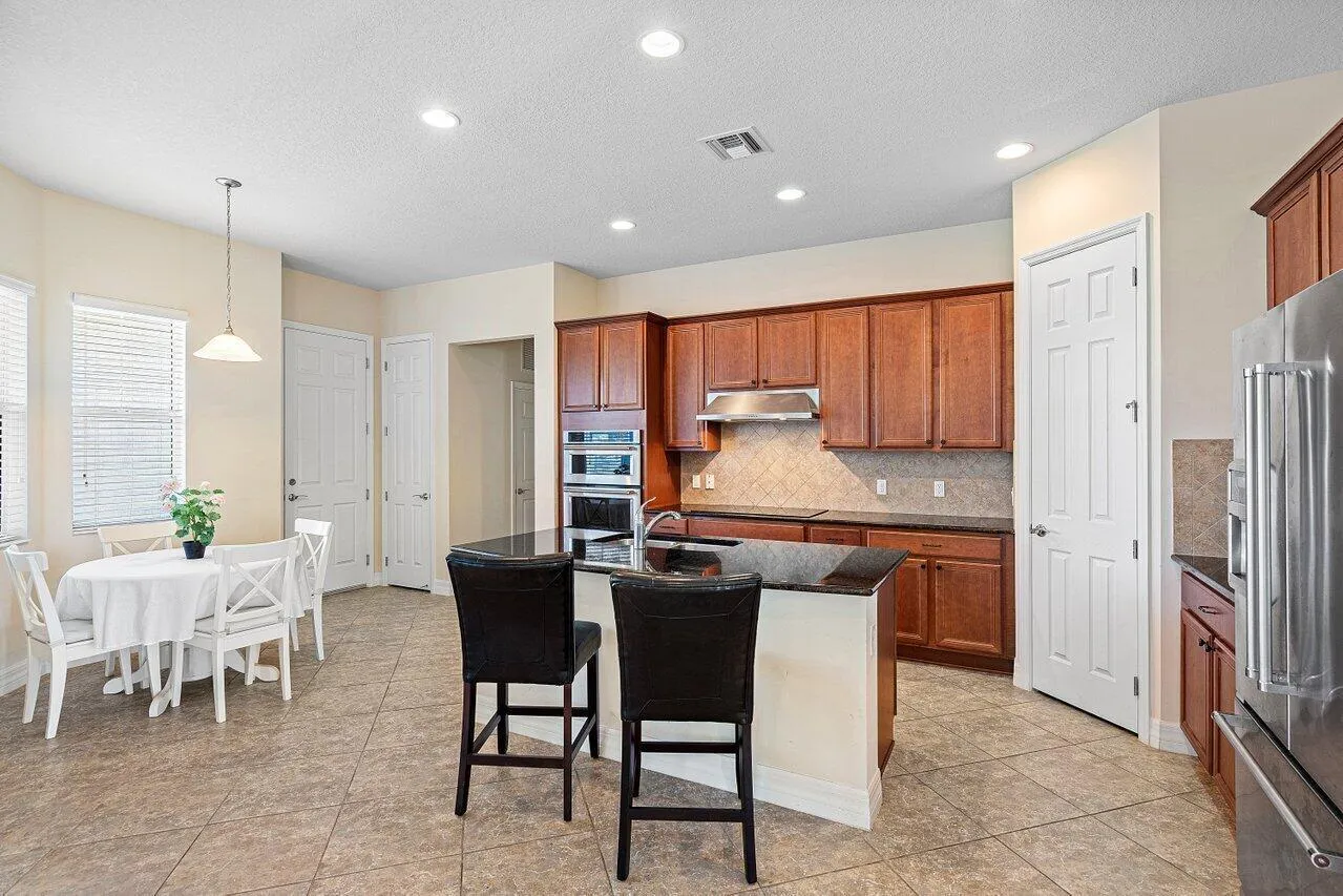 Spacious granite counter extension creates a welcoming barstool eating area.
