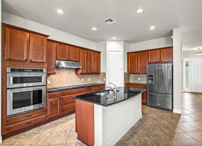 Fully equipped kitchen with stainless-steel appliances.