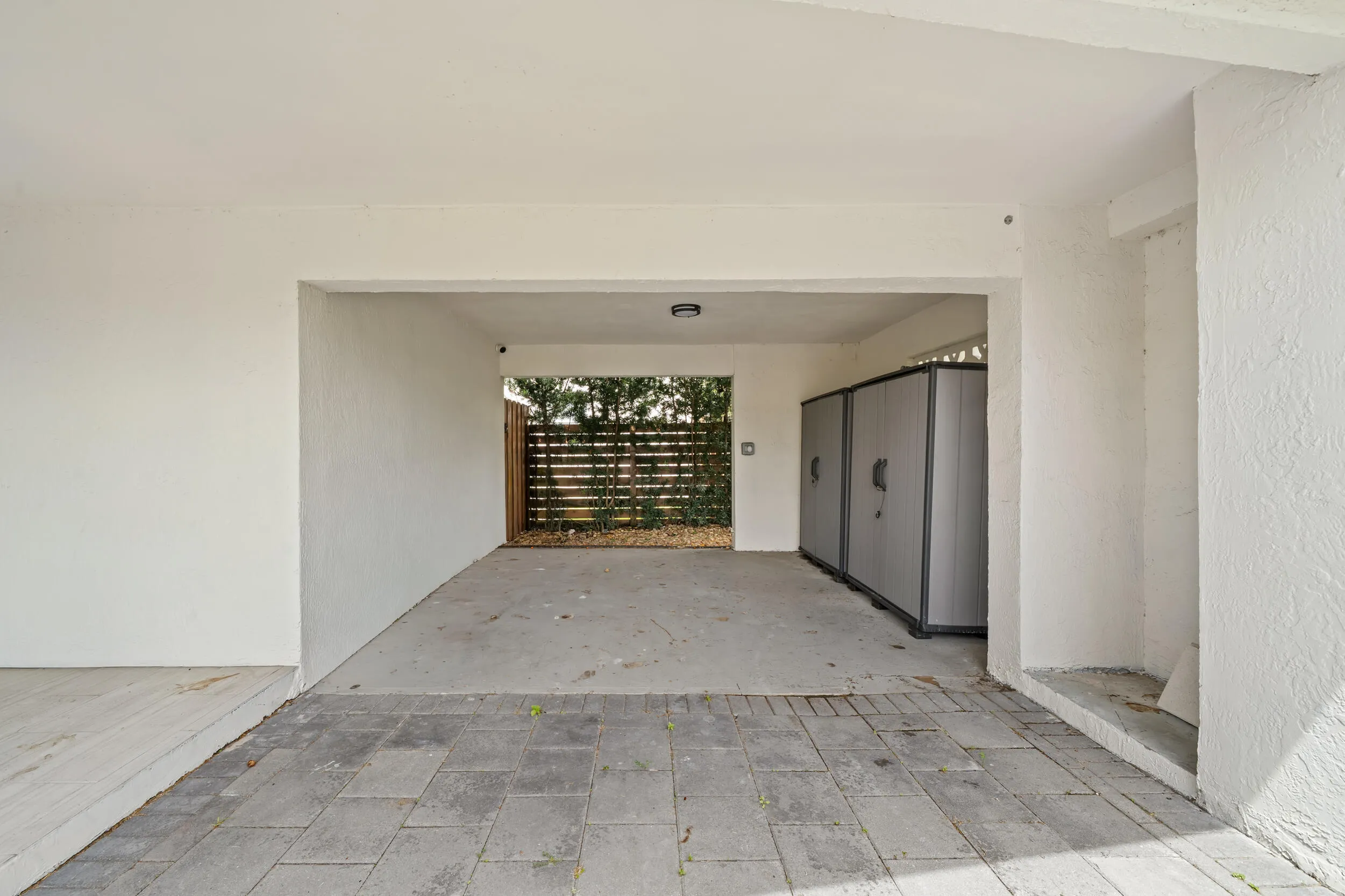 Covered carport with paver stone entry