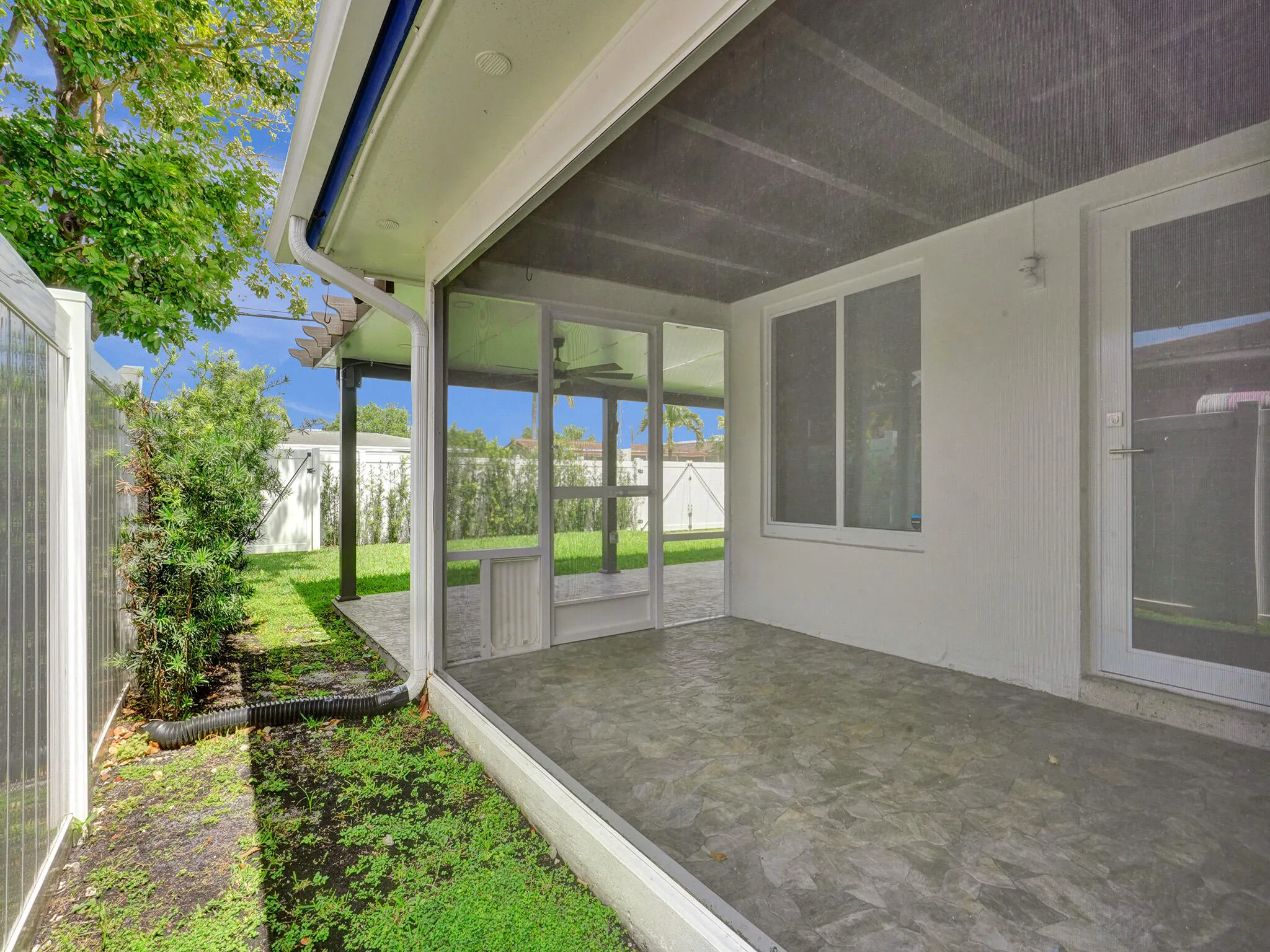 The rear covered and screened patio is large and great for having your morning coffee or entertaining a small group of friends.