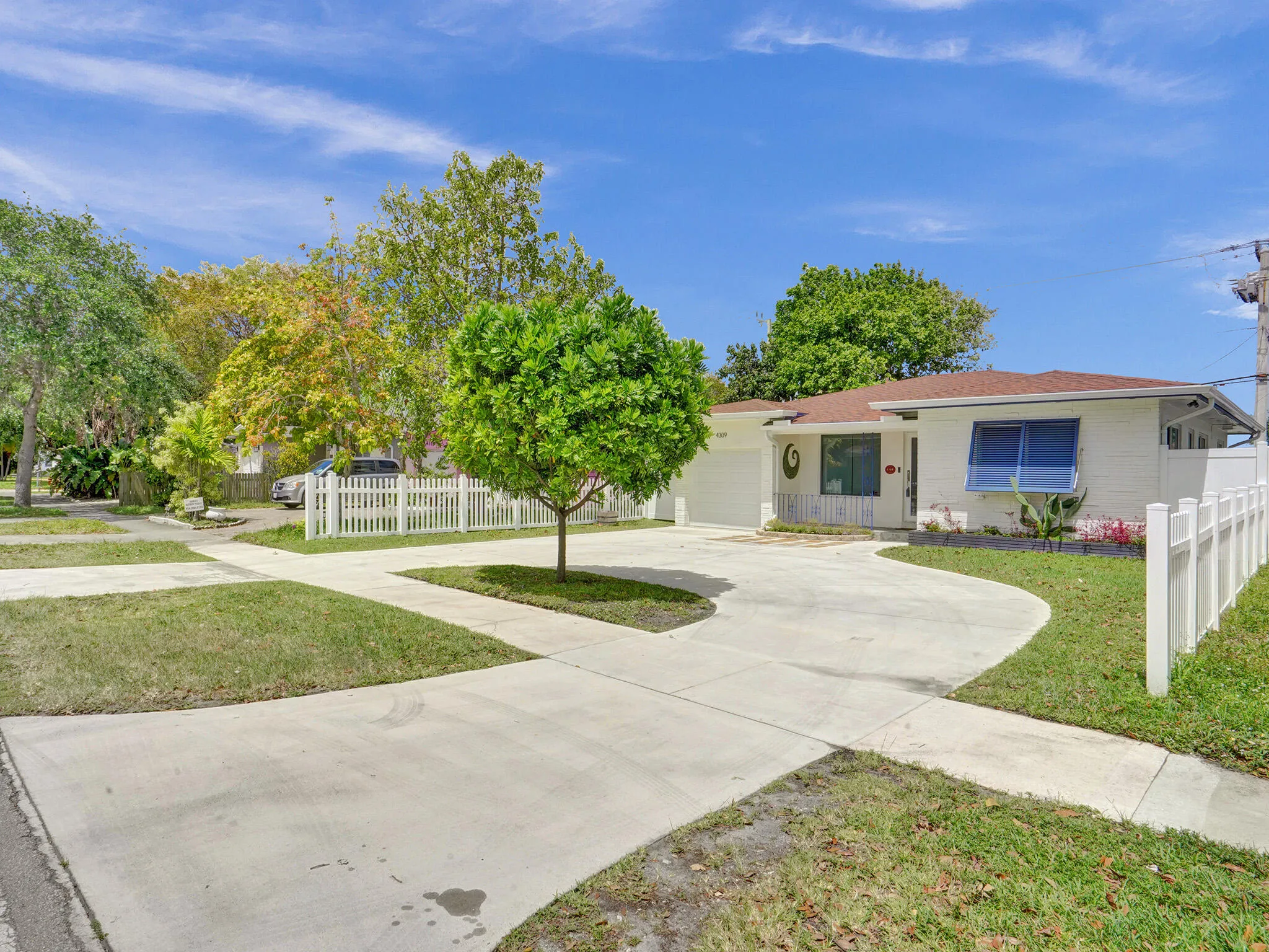 Front entrance with circle driveaway and single car garage with plenty of parking and storage