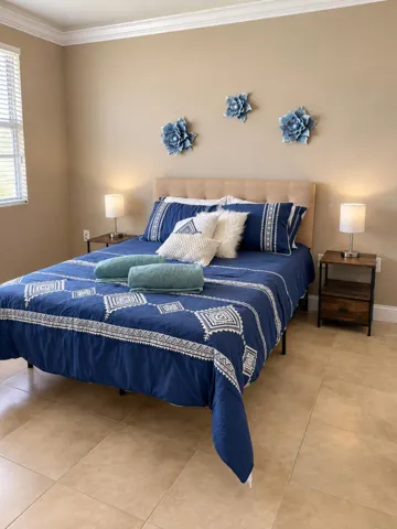 Furnished bedroom with tile flooring and natural light.
