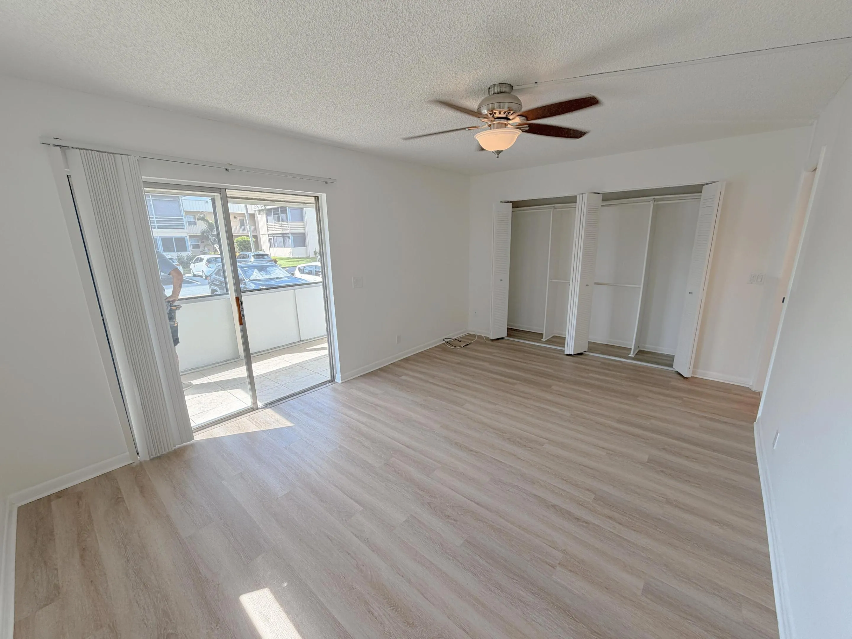 Light wood-finish flooring with white walls