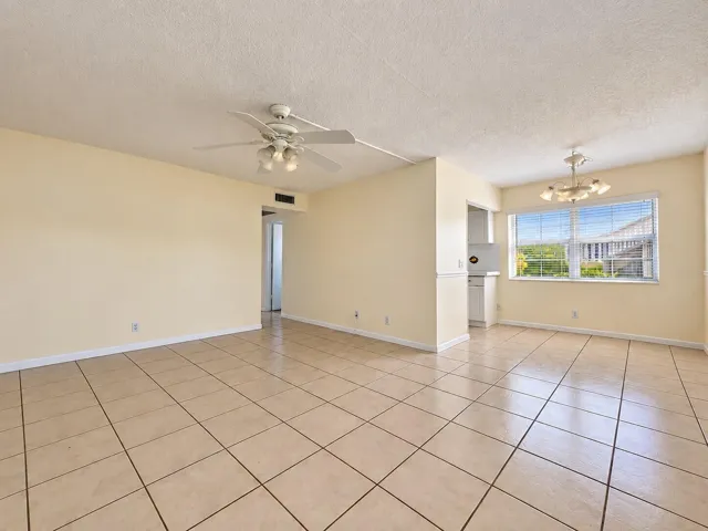 First Floor CORNER 2/1.5 With Water Views. Neutral Tile Flooring Flows Throughout.