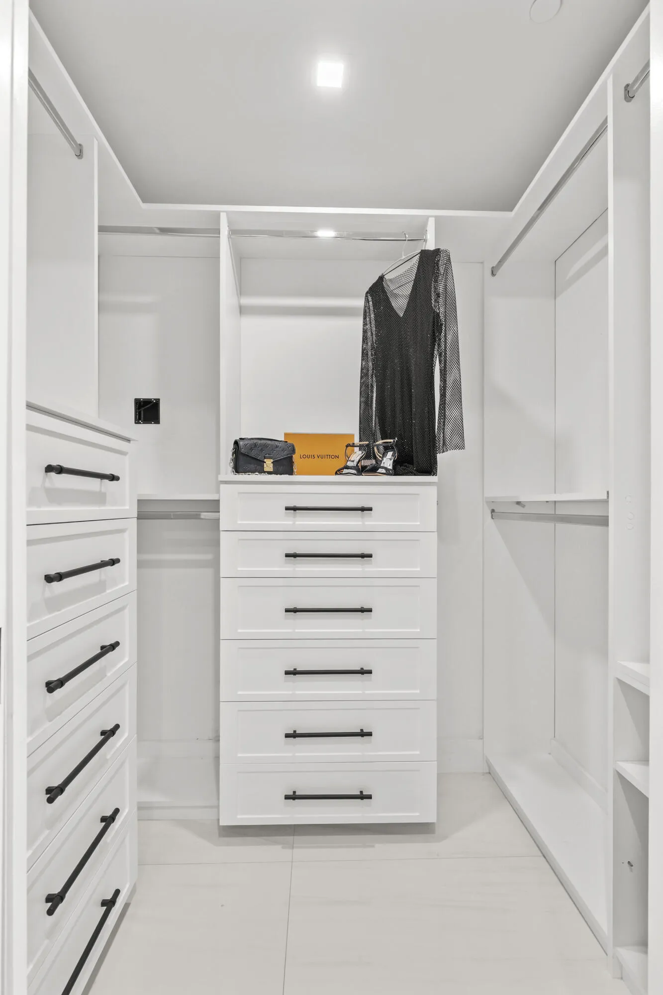 Fully customized cabinetry adorn the his & hers closets providing maximum storage and function.