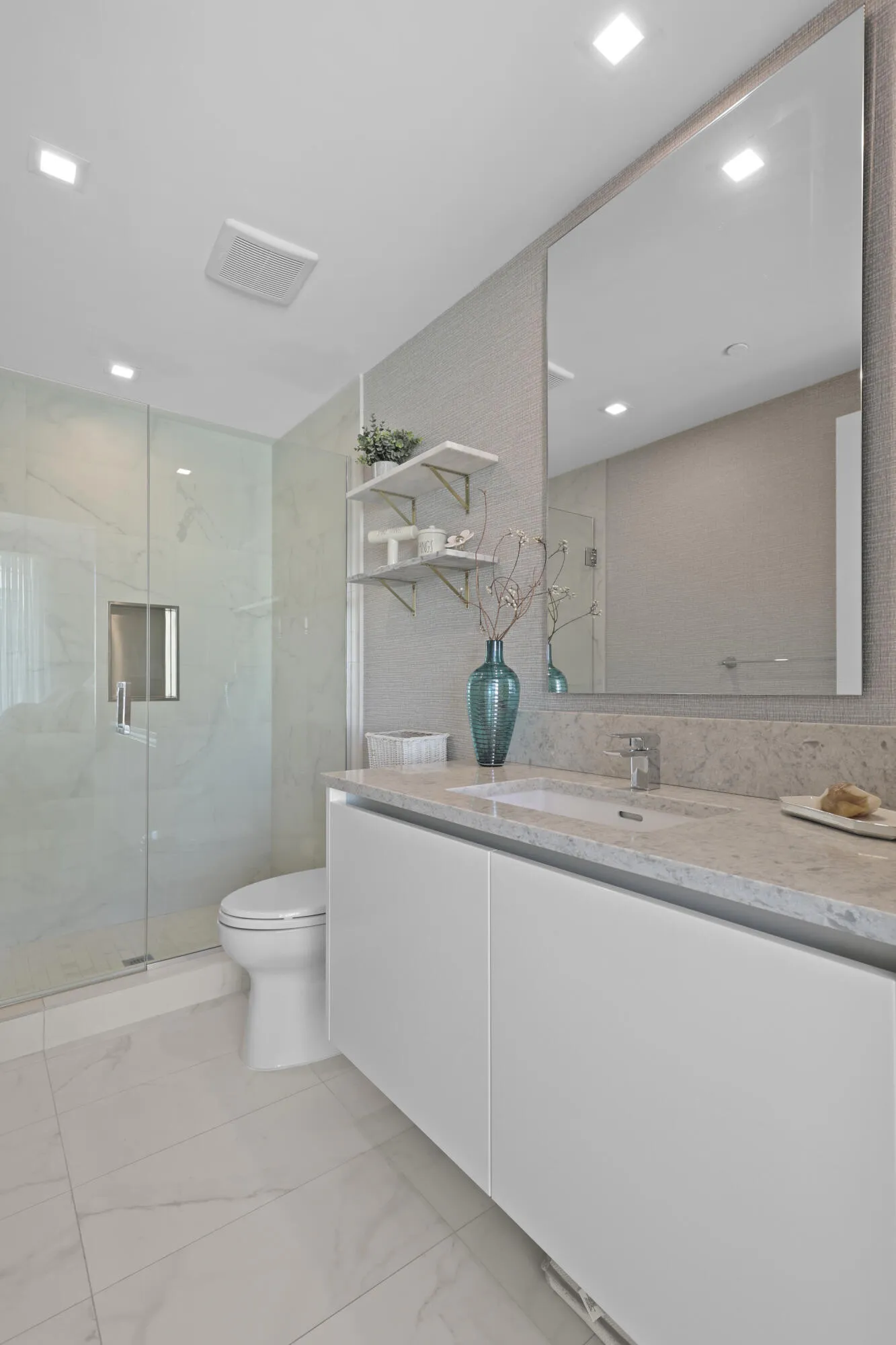 Guest bedroom 1 features more designer touches, automated shades & blinds, customized closet, and ensuite bathroom.
