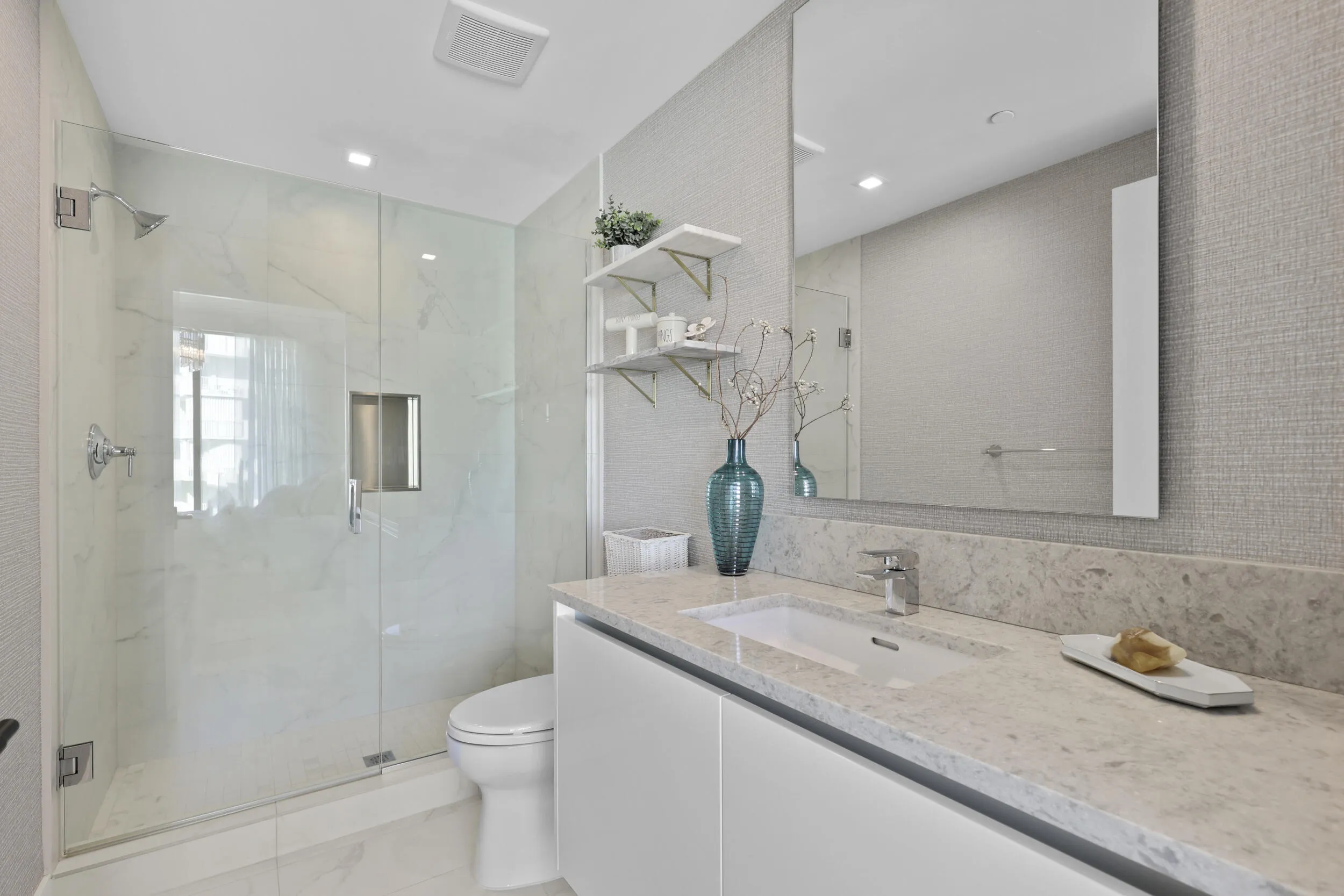 Guest bedroom 1 features more designer touches, automated shades & blinds, customized closet, and ensuite bathroom.