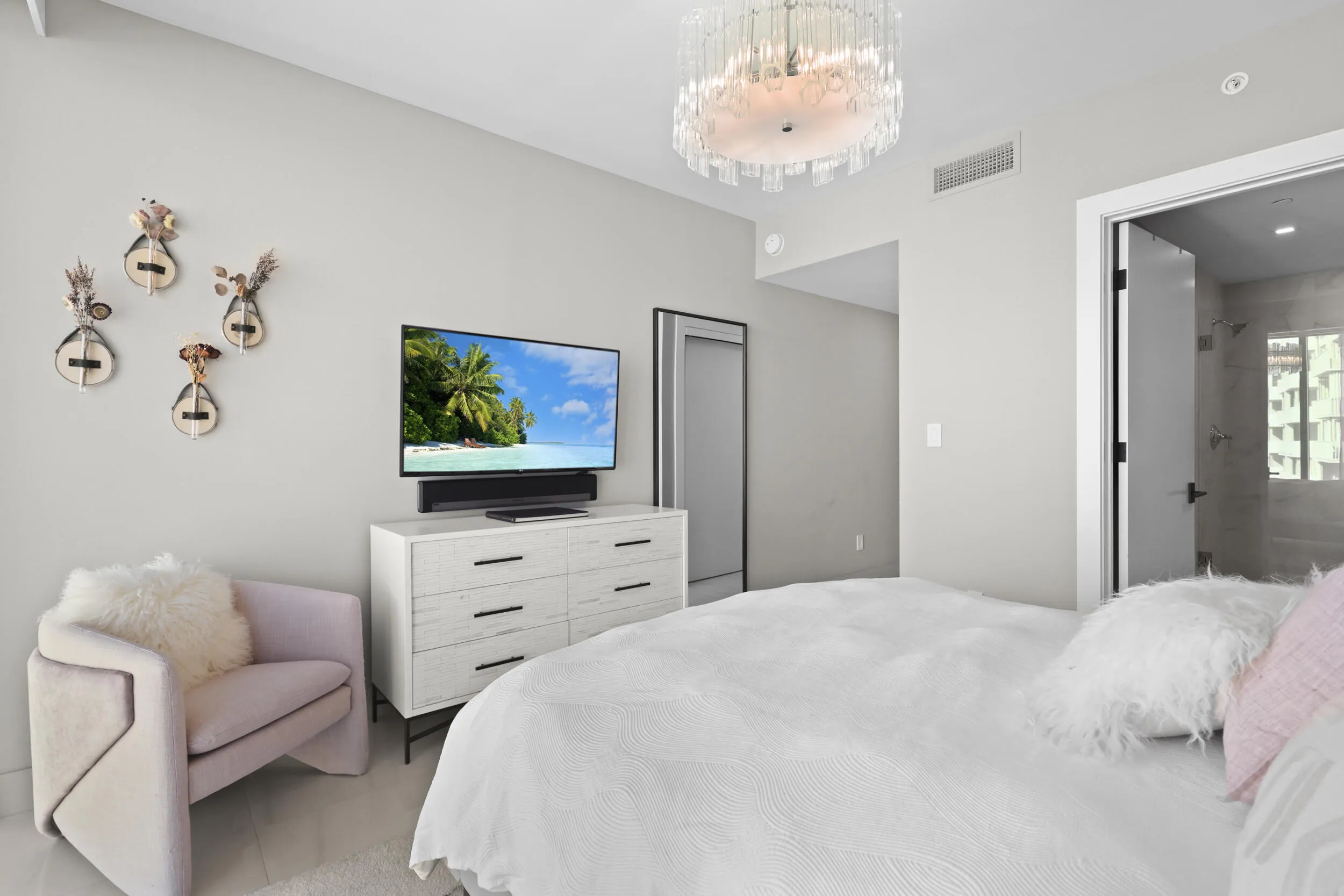 Guest bedroom 1 features more designer touches, automated shades & blinds, customized closet, and ensuite bathroom.