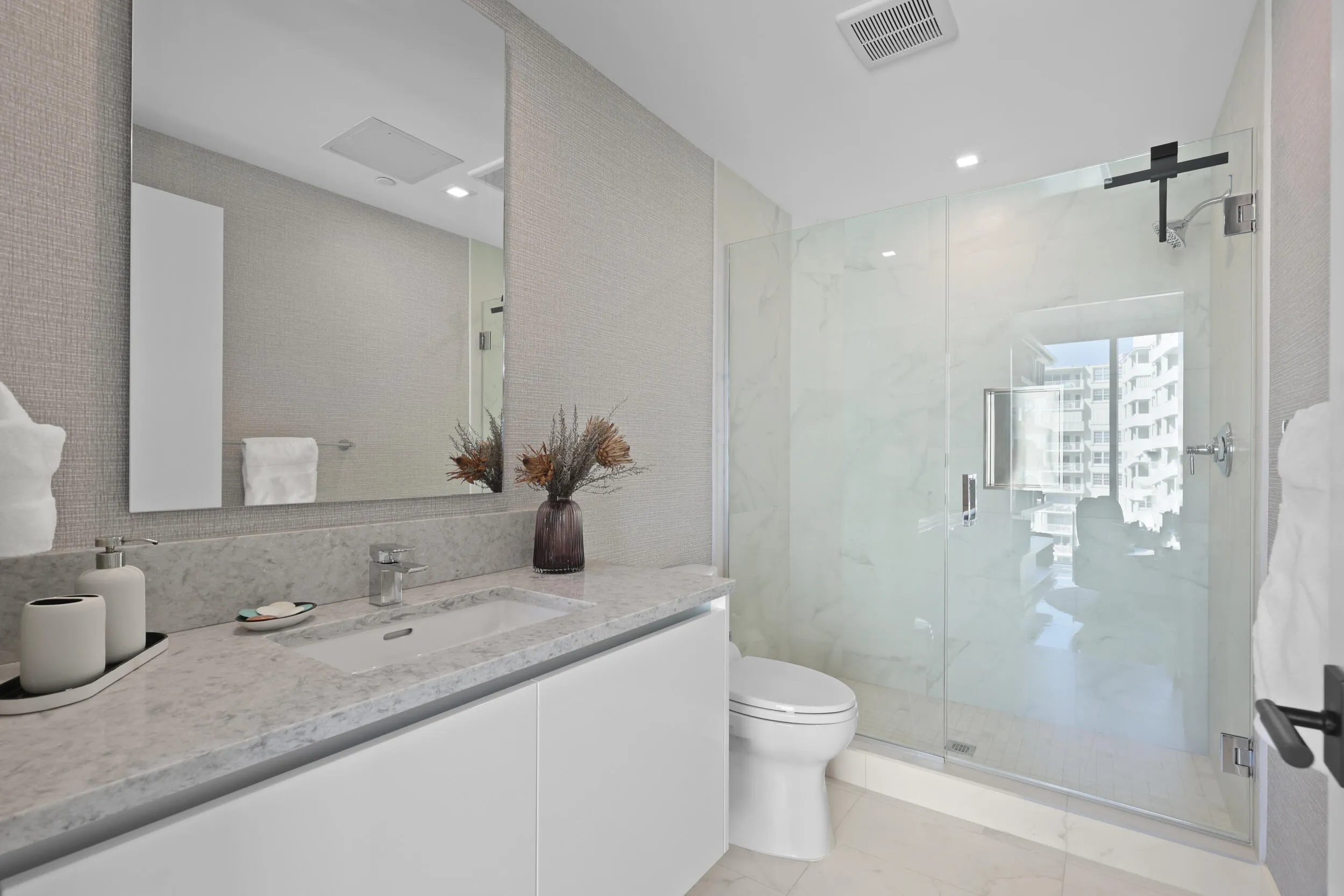 Guest bedroom 2 features more designer touches, automated blinds, customized closet, murphy bed and ensuite bathroom.