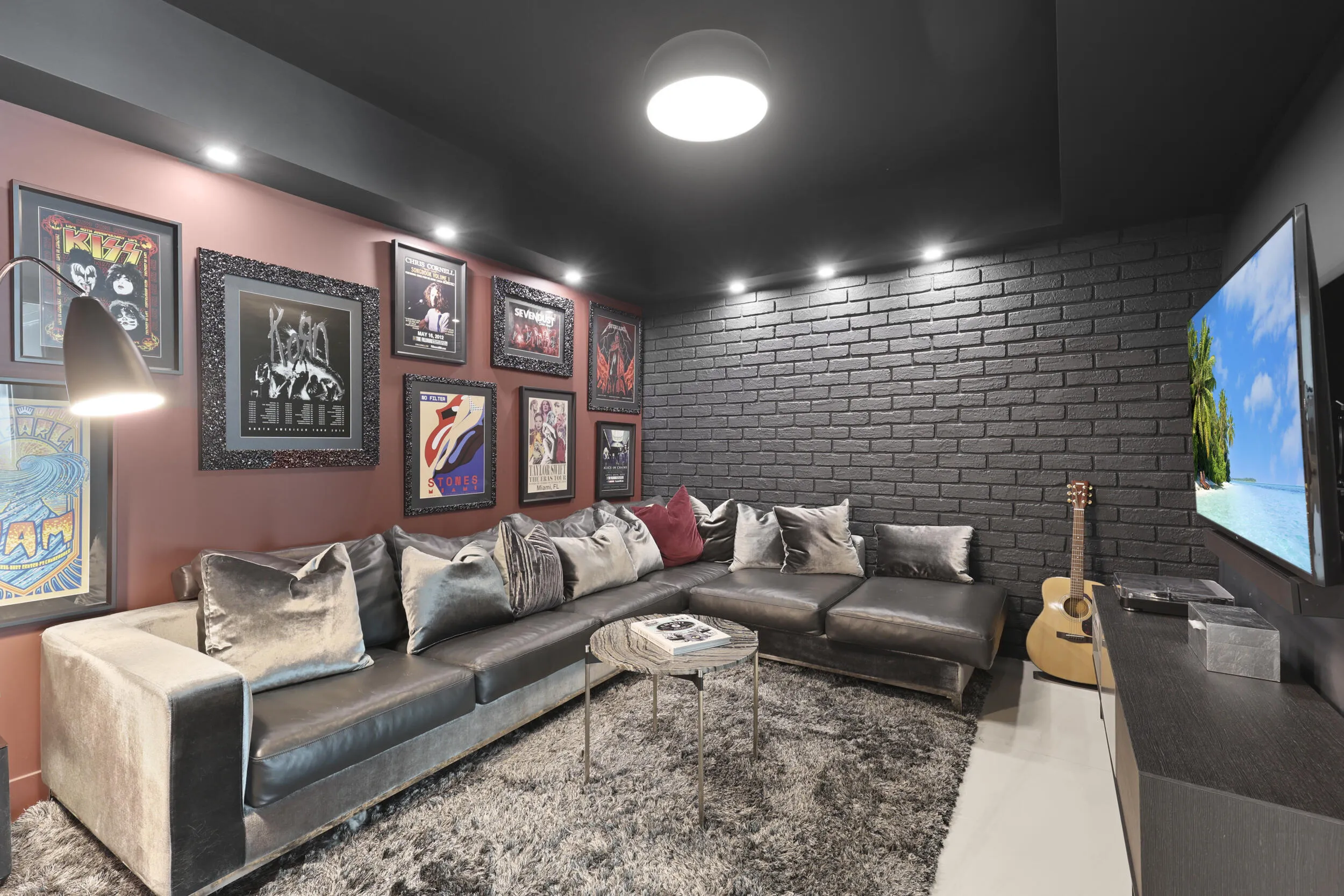 A true showstopper, the den brings bold character and unexpected warmth to this oceanfront residence. A custom faux brick accent wall and dramatic lighting create an unforgettable setting for a movie theater, game room, private office or intimate lounge. Rarely found in a contemporary oceanfront home, this versatile space may also be adapted into a fourth bedroom if desired.