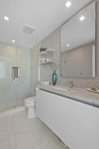 Guest bedroom 1 features more designer touches, automated shades & blinds, customized closet, and ensuite bathroom.