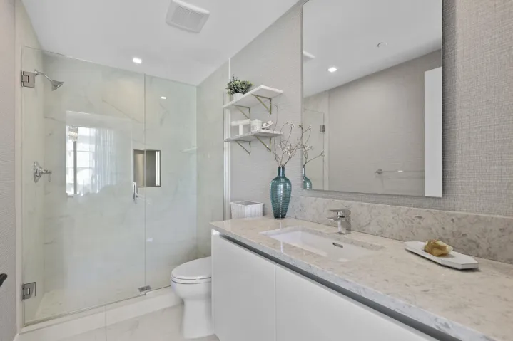 Guest bedroom 1 features more designer touches, automated shades & blinds, customized closet, and ensuite bathroom.