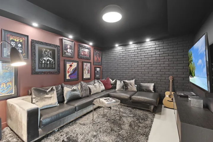 A true showstopper, the den brings bold character and unexpected warmth to this oceanfront residence. A custom faux brick accent wall and dramatic lighting create an unforgettable setting for a movie theater, game room, private office or intimate lounge. Rarely found in a contemporary oceanfront home, this versatile space may also be adapted into a fourth bedroom if desired.