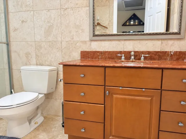 Remodeled bath with tile floor and walls