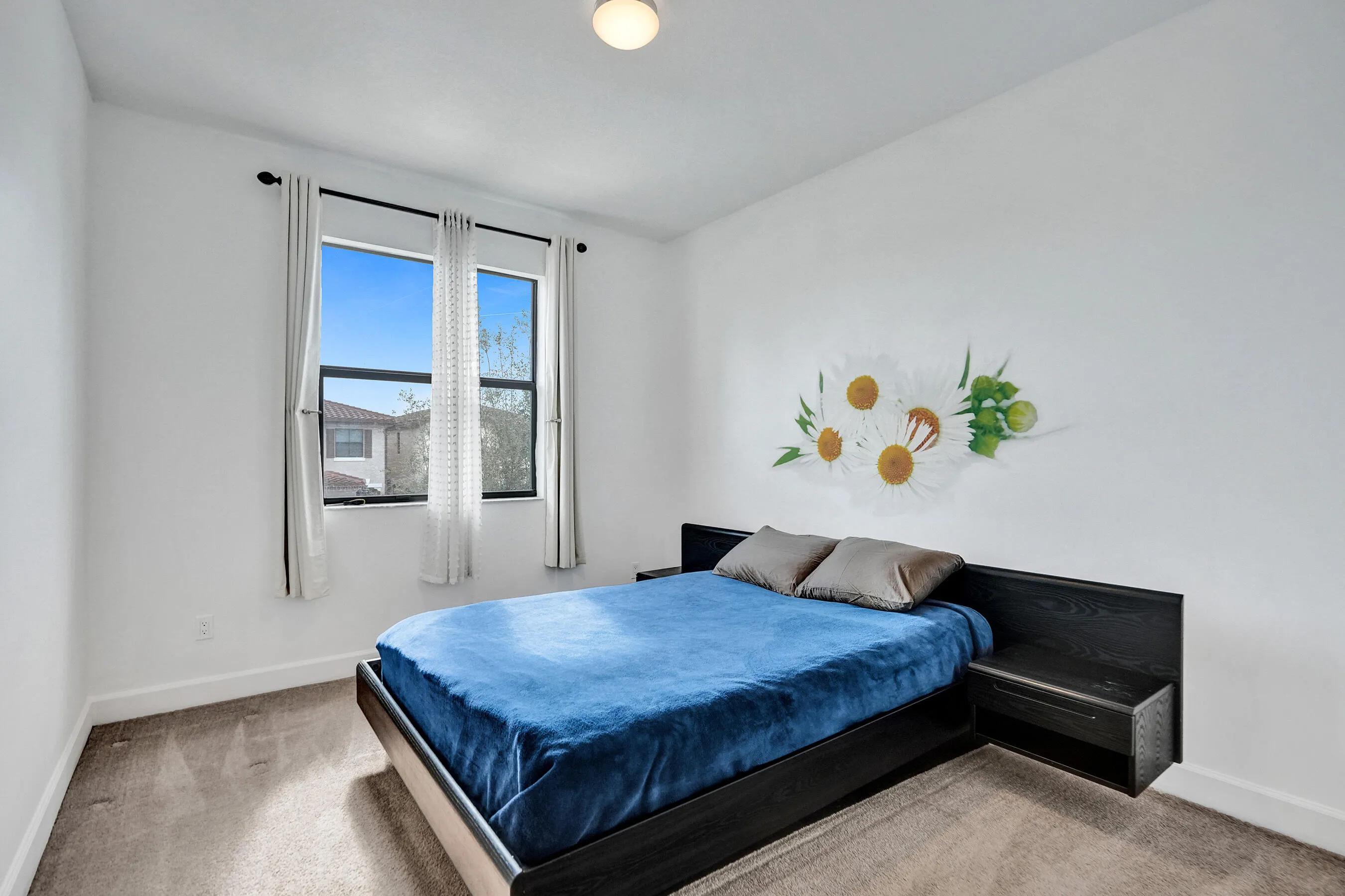 Double-pane window with dark trim, recessed ceiling light, and neutral wall color
