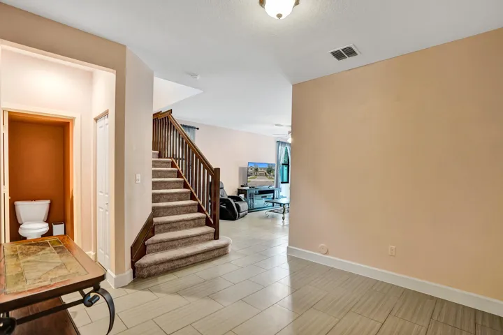 Wood-finish staircase with carpeted treads