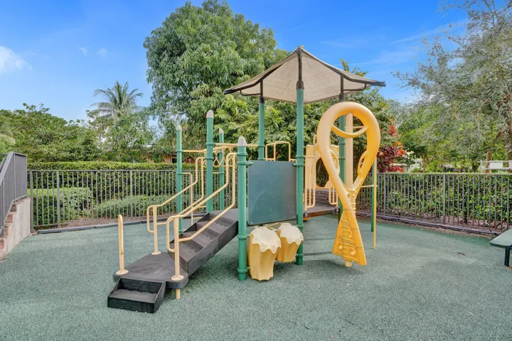 Recreational structure featuring steps, handrails, a covered platform, and a slide component
