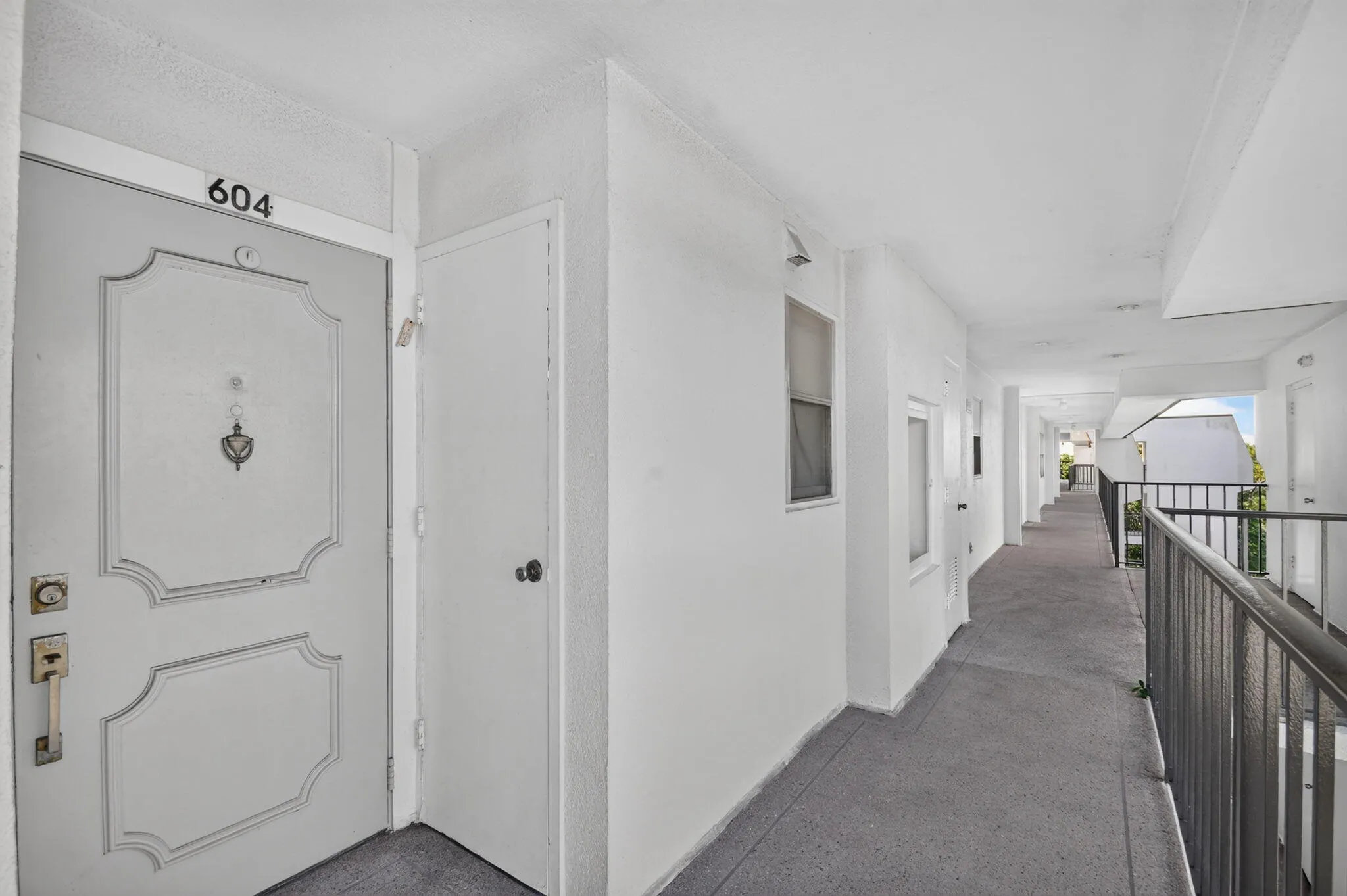 Entry door featuring decorative paneling and numeric address indicator