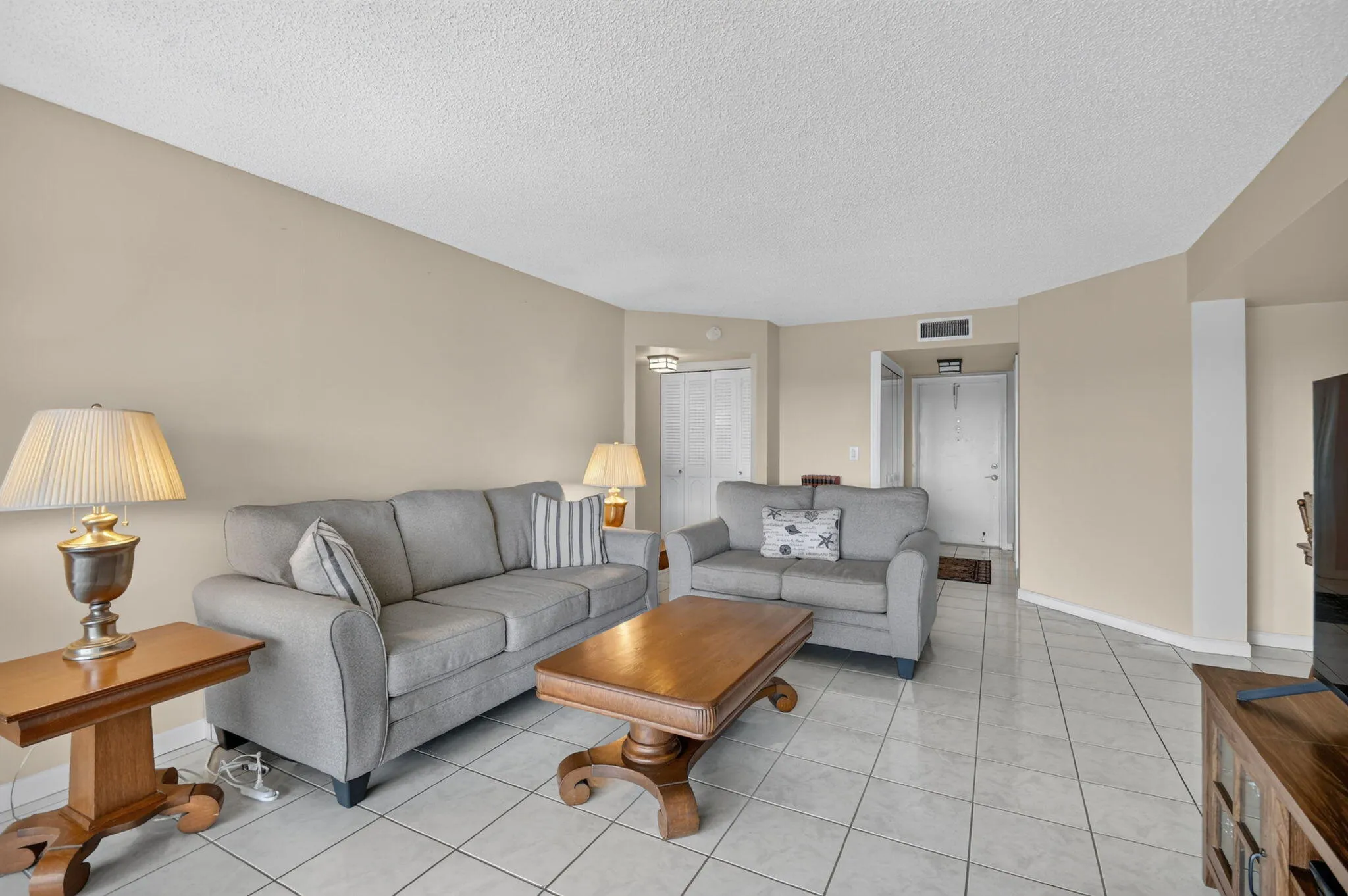 Neutral-toned walls complement the light-colored square tile flooring