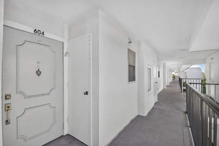 Entry door featuring decorative paneling and numeric address indicator