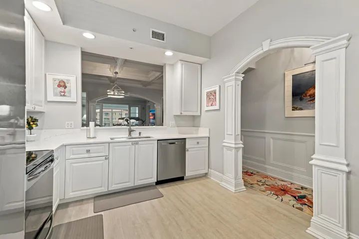 Custom archway in kitchen that mirrors the one separating living/dining area