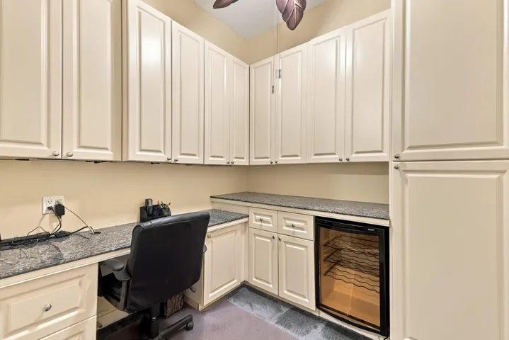 Flex room off laundry area with built-in office and beveridge refrigerator