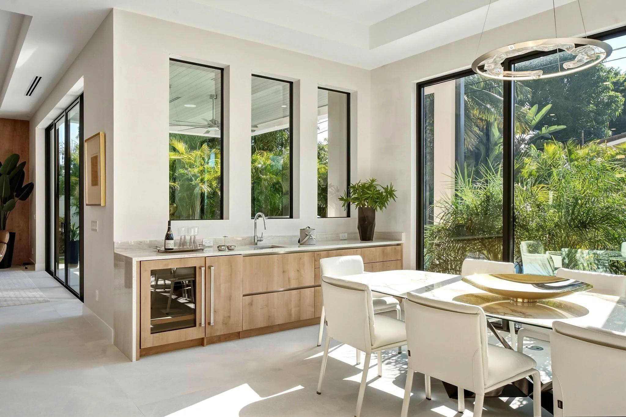 Built-in wet bar with wood-finish cabinetry, under-counter beverage cooler, and integrated​​‌​​​​‌​​‌‌​‌‌​​​‌‌​‌​‌​‌​​​‌​​ sink