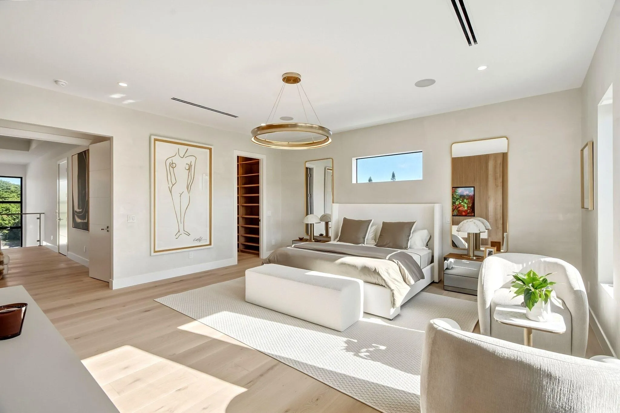 Spacious room featuring wood-finish flooring, recessed lighting, and a contemporary chandelier