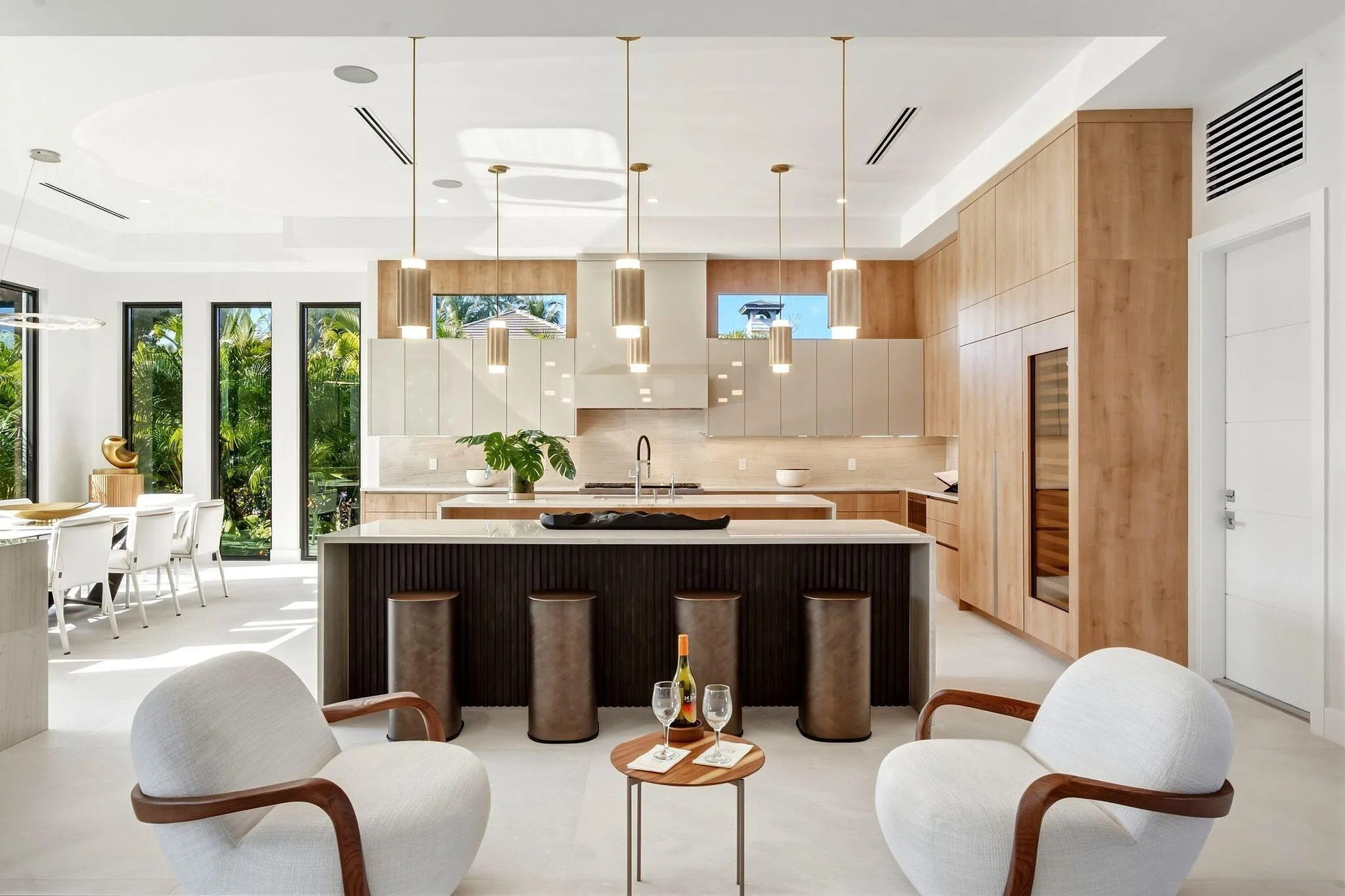 Gourmet kitchen with wood-finish cabinetry, a large center island, and a built-in wine cooler