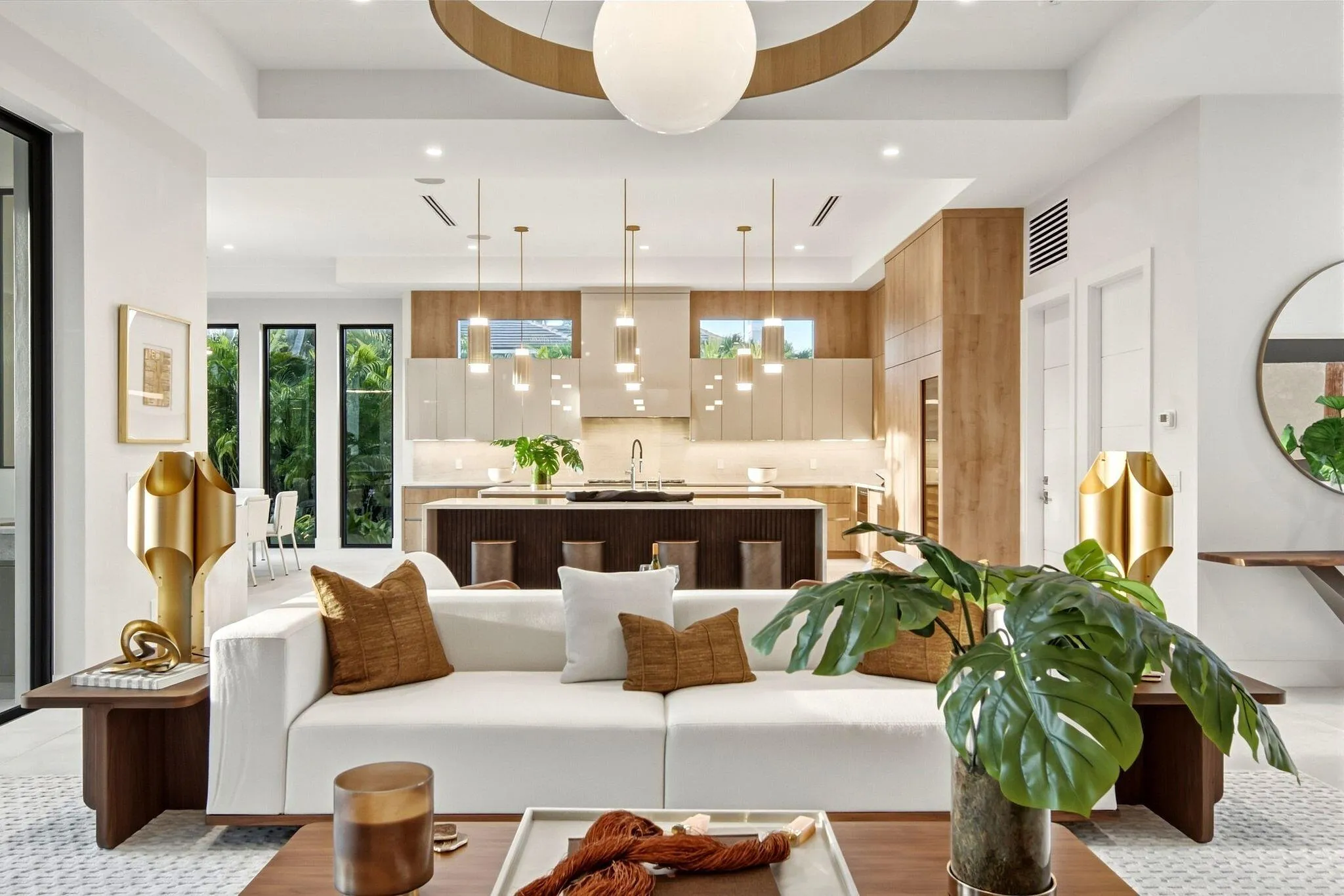 Open-concept interior featuring recessed lighting, a modern kitchen with a central island, and a linear array of pendant lights