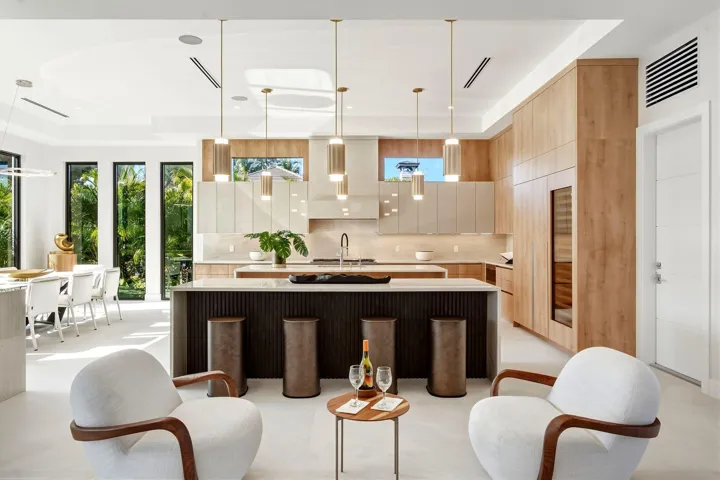 Gourmet kitchen with wood-finish cabinetry, a large center island, and a built-in wine cooler