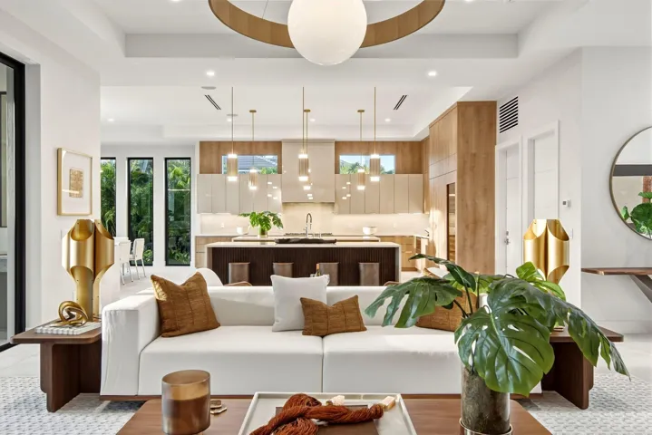 Open-concept interior featuring recessed lighting, a modern kitchen with a central island, and a linear array of pendant lights