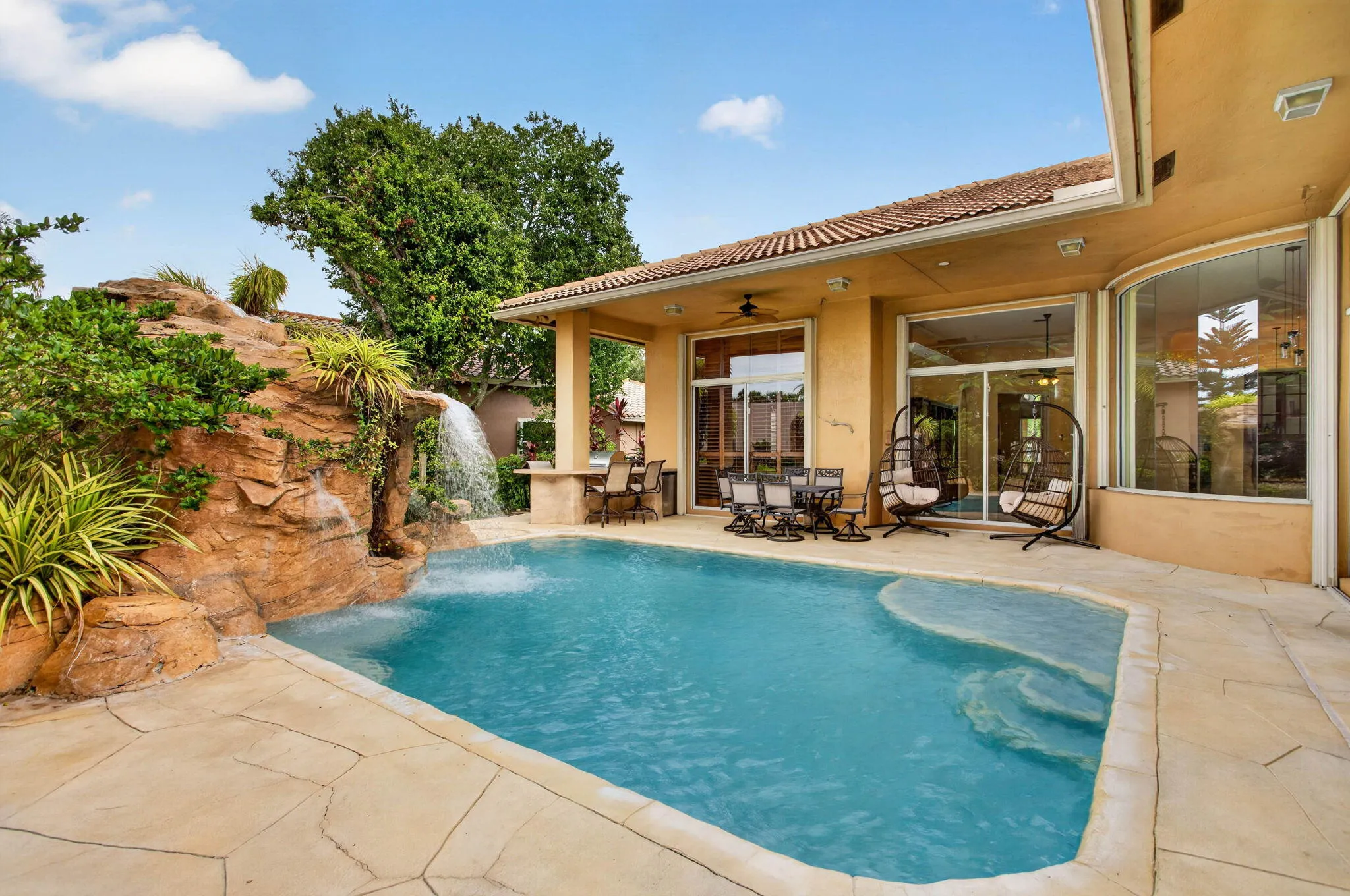 Pool deck. View looking from Fifth bedroom cabana door towards Main bedroom Florida room and breakfast nook windows.