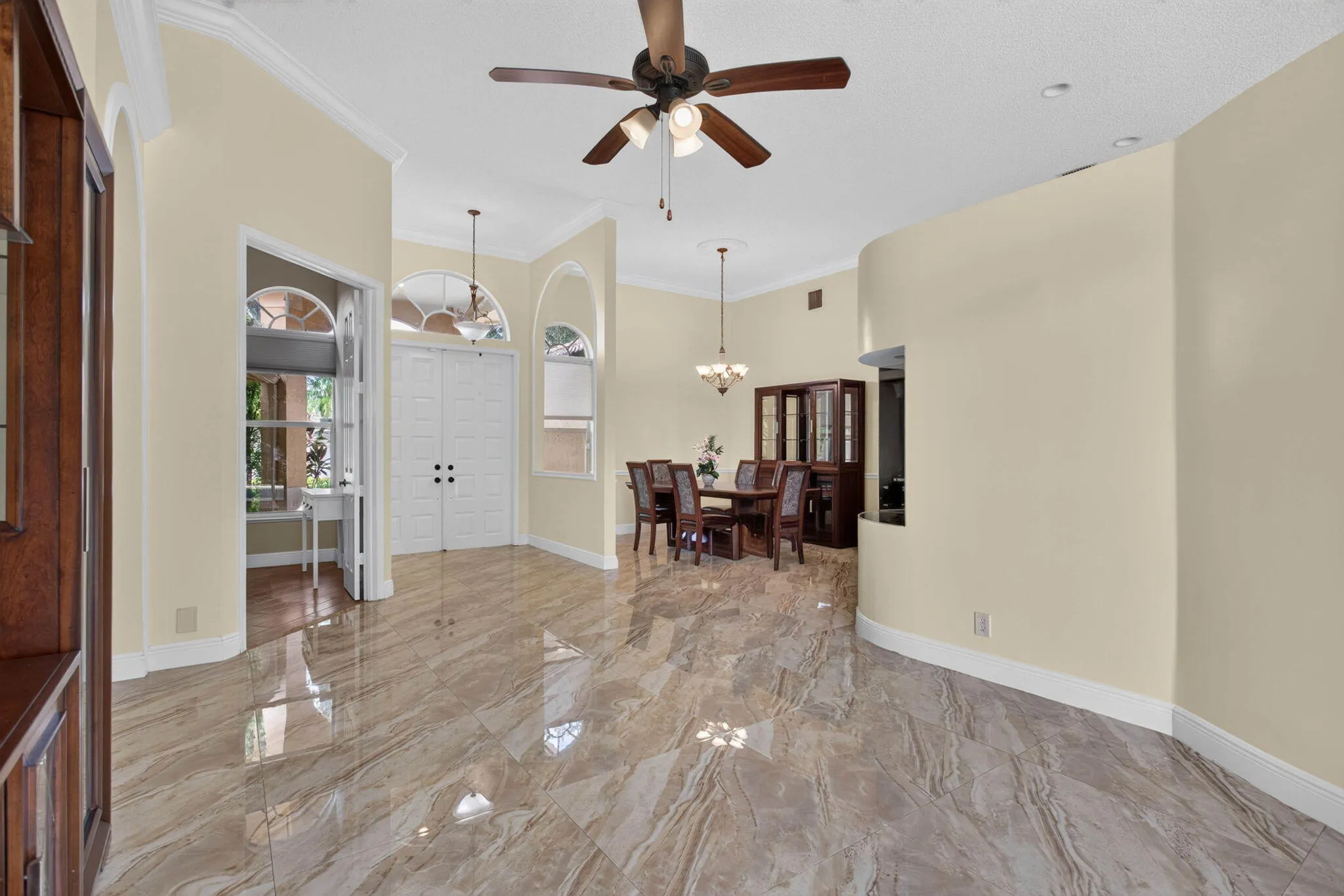 Florida room from Pool sliding doors looking towards dinning room foyer and office/mancave entrance.